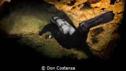 Jared going up Pothole restriction at Peacock Cave System by Don Costanza 